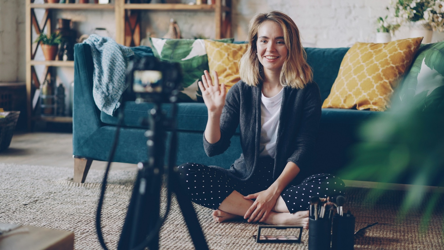 A creator recording a talking-head video from a couch