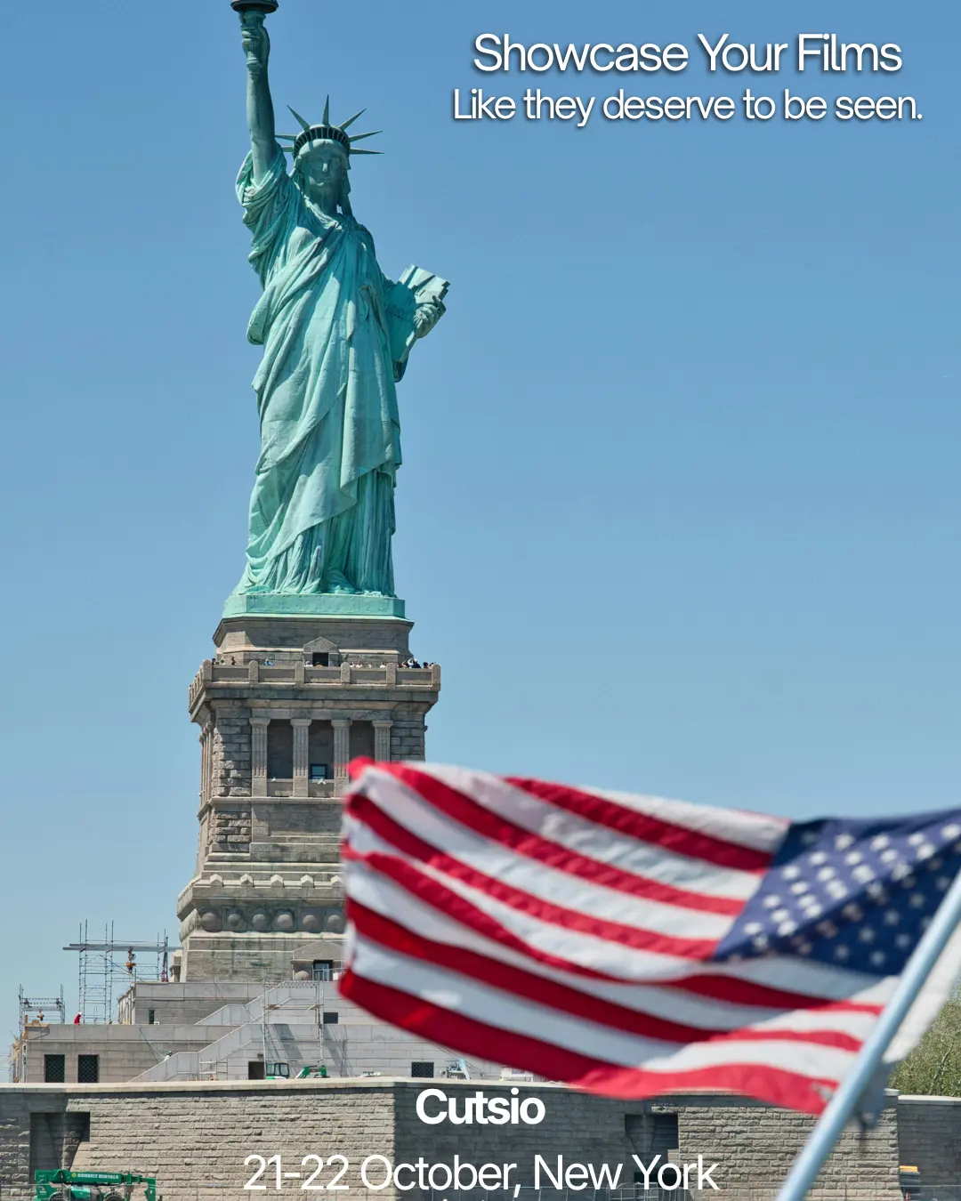 The Statue of Liberty with an American flag in the foreground